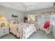 Cozy bedroom with floral bedding, mirrored vanity, and a comfortable armchair at 507 Monaco Dr, Punta Gorda, FL 33950