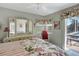 Bedroom with floral bedding, mirrored vanity, and access to outdoor pool at 507 Monaco Dr, Punta Gorda, FL 33950