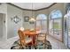 Cozy breakfast nook with arched windows and a round table, perfect for casual dining and morning coffee at 507 Monaco Dr, Punta Gorda, FL 33950