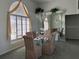 Dining room featuring a chandelier and large window with curtains, creating a warm atmosphere at 507 Monaco Dr, Punta Gorda, FL 33950