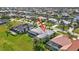 Aerial view highlighting the home's screened-in pool and lush, green lawn in a residential area at 507 Monaco Dr, Punta Gorda, FL 33950