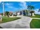Beautiful home featuring an inviting drive and lush, tropical landscaping at 507 Monaco Dr, Punta Gorda, FL 33950