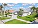 Home exterior showcasing lush landscaping, driveway and palm trees at 507 Monaco Dr, Punta Gorda, FL 33950