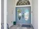 Elegant front door with decorative wreath and sidelights, creating a welcoming entrance to the home at 507 Monaco Dr, Punta Gorda, FL 33950