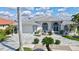 Beautiful single-story home featuring a well-manicured front lawn, palm trees, decorative rock, and a tile roof at 507 Monaco Dr, Punta Gorda, FL 33950