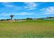 Lush green golf course with water feature and blue skies at 507 Monaco Dr, Punta Gorda, FL 33950