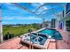 Relaxing hot tub overlooking the sparkling pool and lush green golf course, offering a serene retreat at 507 Monaco Dr, Punta Gorda, FL 33950