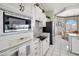 Well-appointed kitchen with white appliances, including built-in microwave and cooktop, offering functionality and style at 507 Monaco Dr, Punta Gorda, FL 33950