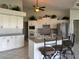 Bright kitchen featuring white cabinets, gray countertops, and stainless steel appliances at 507 Monaco Dr, Punta Gorda, FL 33950