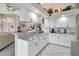 Well-lit kitchen with white cabinets, a long countertop, and a view into the living area at 507 Monaco Dr, Punta Gorda, FL 33950