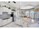 Bright kitchen with white cabinetry, stainless steel appliances, and a breakfast nook for easy meals at 507 Monaco Dr, Punta Gorda, FL 33950