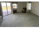 Spacious living room with a comfortable armchair and sliding glass doors leading to the pool at 507 Monaco Dr, Punta Gorda, FL 33950