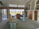 Inviting living room featuring large windows overlooking a water view, comfortable seating, and built-in shelving at 507 Monaco Dr, Punta Gorda, FL 33950