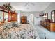 Spacious main bedroom features floral bedding, wood furniture, and a ceiling fan at 507 Monaco Dr, Punta Gorda, FL 33950