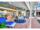 Inviting covered patio with comfortable seating area, overlooking a sparkling pool, and scenic golf course views at 507 Monaco Dr, Punta Gorda, FL 33950