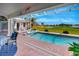 Stunning pool and hot tub, complemented by beautiful views of the lush golf course and serene lake at 507 Monaco Dr, Punta Gorda, FL 33950