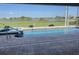 A relaxing outdoor pool and jacuzzi with a scenic view of the golf course and pond at 507 Monaco Dr, Punta Gorda, FL 33950
