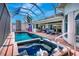 Enclosed pool and spa area with brick patio, seating and beautiful views at 507 Monaco Dr, Punta Gorda, FL 33950