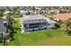 Aerial view of a screened-in pool and hot tub with a well-manicured lawn and landscaping at 507 Monaco Dr, Punta Gorda, FL 33950