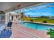 Screened in pool with a beautiful view of a green golf course and a lake at 507 Monaco Dr, Punta Gorda, FL 33950