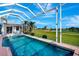 Screened-in pool with an adjacent golf course view, inviting relaxation and recreation in a luxurious setting at 507 Monaco Dr, Punta Gorda, FL 33950
