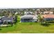 Expansive backyard featuring a spacious green lawn and a screened-in lanai with a pool and spa at 507 Monaco Dr, Punta Gorda, FL 33950