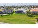 Expansive backyard featuring a spacious green lawn and a screened-in lanai with a pool and spa at 507 Monaco Dr, Punta Gorda, FL 33950