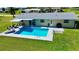 Aerial view of the backyard pool with lounge chairs and patio seating at 61 Caddy Rd, Rotonda West, FL 33947