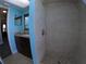 Shower with tile surround, dark wood vanity, and tile flooring at 61 Caddy Rd, Rotonda West, FL 33947