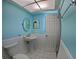 Well-lit bathroom featuring a stylish pedestal sink, and an updated tile floor at 61 Caddy Rd, Rotonda West, FL 33947