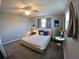 Comfortable bedroom with two windows, ceiling fan, and neutral decor at 61 Caddy Rd, Rotonda West, FL 33947