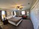 Bedroom with a large bed, ceiling fan, carpet flooring and ample closet space at 61 Caddy Rd, Rotonda West, FL 33947