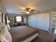 Bedroom featuring a large bed, ceiling fan, carpet flooring and closet space at 61 Caddy Rd, Rotonda West, FL 33947