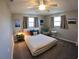 Well-lit bedroom with two windows, a ceiling fan, and soft carpeting at 61 Caddy Rd, Rotonda West, FL 33947
