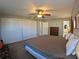 Bedroom with closet space, ceiling fan, large bed, and ensuite bathroom at 61 Caddy Rd, Rotonda West, FL 33947