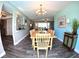 Bright dining area featuring wood-look tile floors, modern chandelier, and an open floor plan at 61 Caddy Rd, Rotonda West, FL 33947