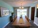 Bright dining space with waterfront views, chandelier, and natural light at 61 Caddy Rd, Rotonda West, FL 33947