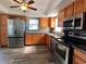 Well-lit kitchen featuring stainless steel appliances and tiled backsplash at 61 Caddy Rd, Rotonda West, FL 33947