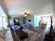 Bright living room open to dining area with tile floors and neutral decor at 61 Caddy Rd, Rotonda West, FL 33947