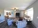 Cozy living room with an open floor plan, featuring hardwood floors and comfortable furniture, connecting to dining area at 61 Caddy Rd, Rotonda West, FL 33947