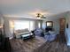 Open-concept living room features wood-look tile flooring and comfortable seating at 61 Caddy Rd, Rotonda West, FL 33947