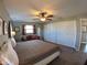 Bright bedroom with a ceiling fan, carpet, and a closet with sliding doors at 61 Caddy Rd, Rotonda West, FL 33947