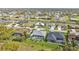 Wide aerial view showcasing numerous homes in a community with canals and lush landscaping at 664 Rotonda Cir, Rotonda West, FL 33947