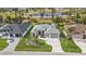 Attractive home featuring lush landscaping, paver driveway, two-car garage and community lake in the background at 664 Rotonda Cir, Rotonda West, FL 33947