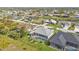 Wide aerial view showing numerous homes in a community with canals and lush landscaping at 664 Rotonda Cir, Rotonda West, FL 33947