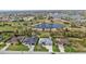 Beautiful aerial view of several homes in a neighborhood near a serene lake and golf course at 664 Rotonda Cir, Rotonda West, FL 33947