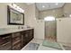 Modern bathroom featuring dual shower heads, dark wood cabinets and granite countertops at 664 Rotonda Cir, Rotonda West, FL 33947