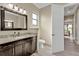 Well-lit bathroom with wood-look tile flooring, dark wood cabinets and granite countertop at 664 Rotonda Cir, Rotonda West, FL 33947