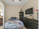 Cozy bedroom with a TV and adjacent bathroom at 664 Rotonda Cir, Rotonda West, FL 33947
