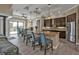 Open kitchen featuring an island with barstool seating, stainless steel appliances, and wood-look tile flooring at 664 Rotonda Cir, Rotonda West, FL 33947